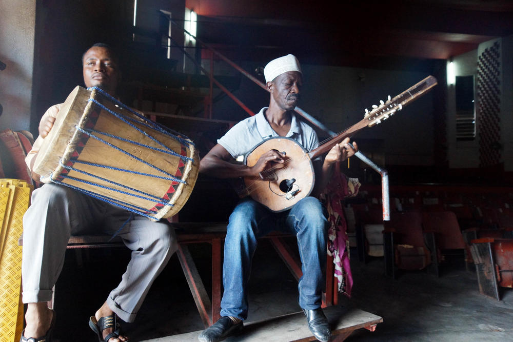 A street performance in downtown Moroni, the capital of Comoros: Drummer D. Alimzé joins Comorian member M'madi Djibaba as they play their handmade instruments.