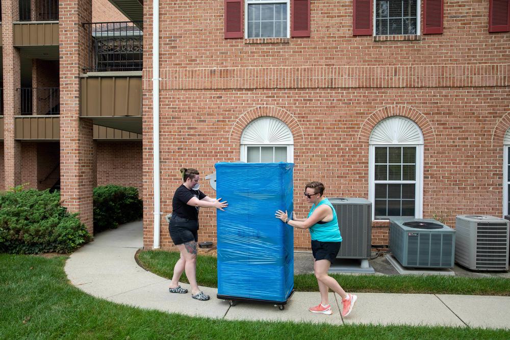 Patient care technician Ariel (left) and Morgan Nuzzo bring in equipment at the site of the Partners in Abortion Care clinic, which will specialize in all-trimester abortion care. (Ariel and other staff asked that we use only their first names out of security concerns.)