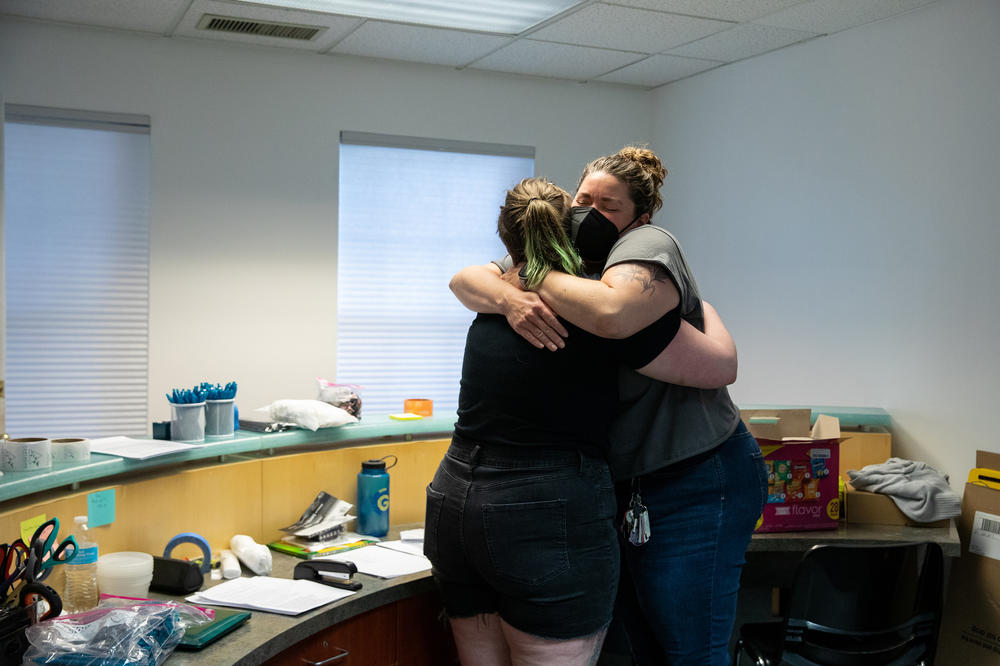 Dr. Diane Horvath hugs patient care technician Ariel. 