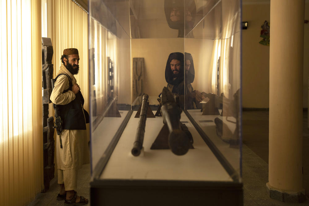 Taliban fighter Mansoor Zulfiqar, left, visits the National Museum of Afghanistan, in Kabul on Dec. 6, 2021.