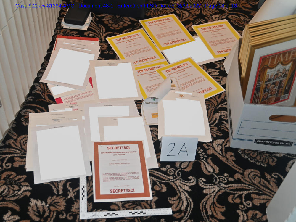 This image contained in a court filing by the Department of Justice on Aug. 30, 2022, and redacted by in part by the FBI, shows a photo of documents seized during the Aug. 8 search by the FBI of former President Donald Trump's Mar-a-Lago estate in Florida.