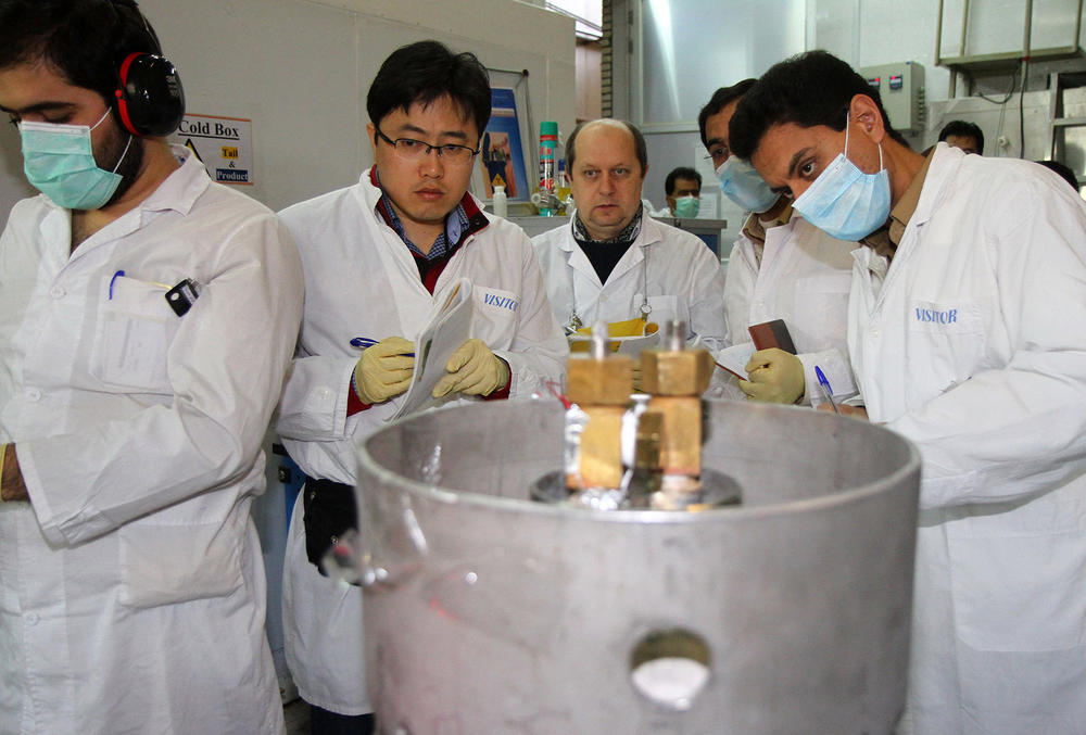 IAEA inspectors (second and third left) and Iranian technicians at a nuclear research center in Natanz, Iran, in 2014.