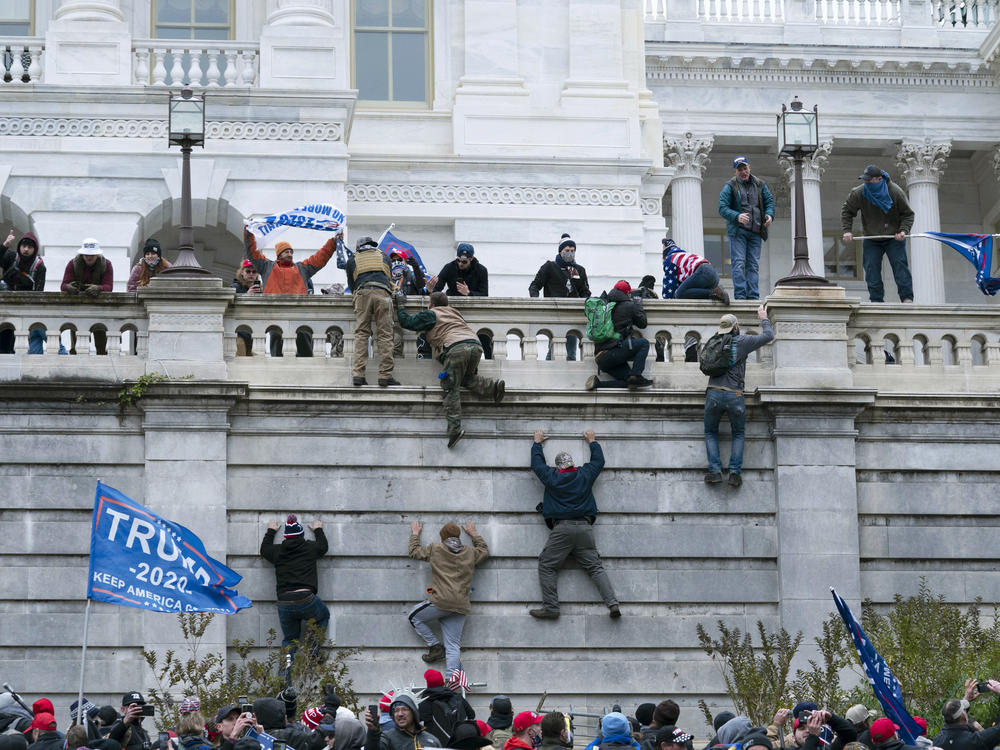 Insurrectionists loyal to President Donald Trump scale the west wall of the the U.S. Capitol on Jan. 6, 2021.