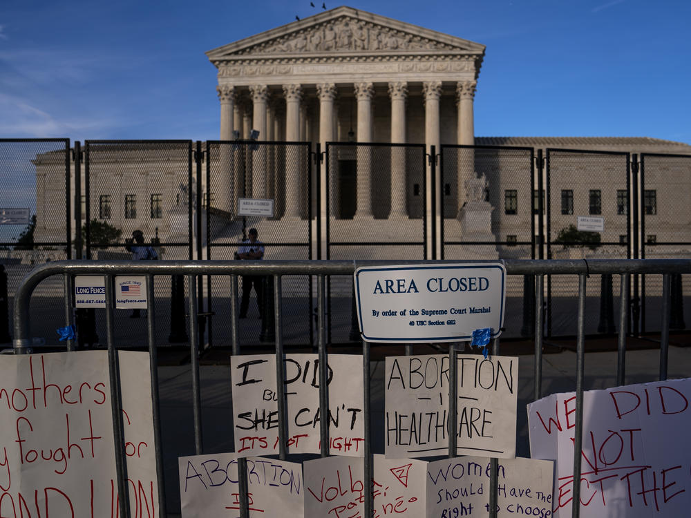 Signs left by abortion-rights supporters line the security fence surrounding the Supreme Court on June 28, after the court overturned Roe v Wade, ending the federal right to an abortion.