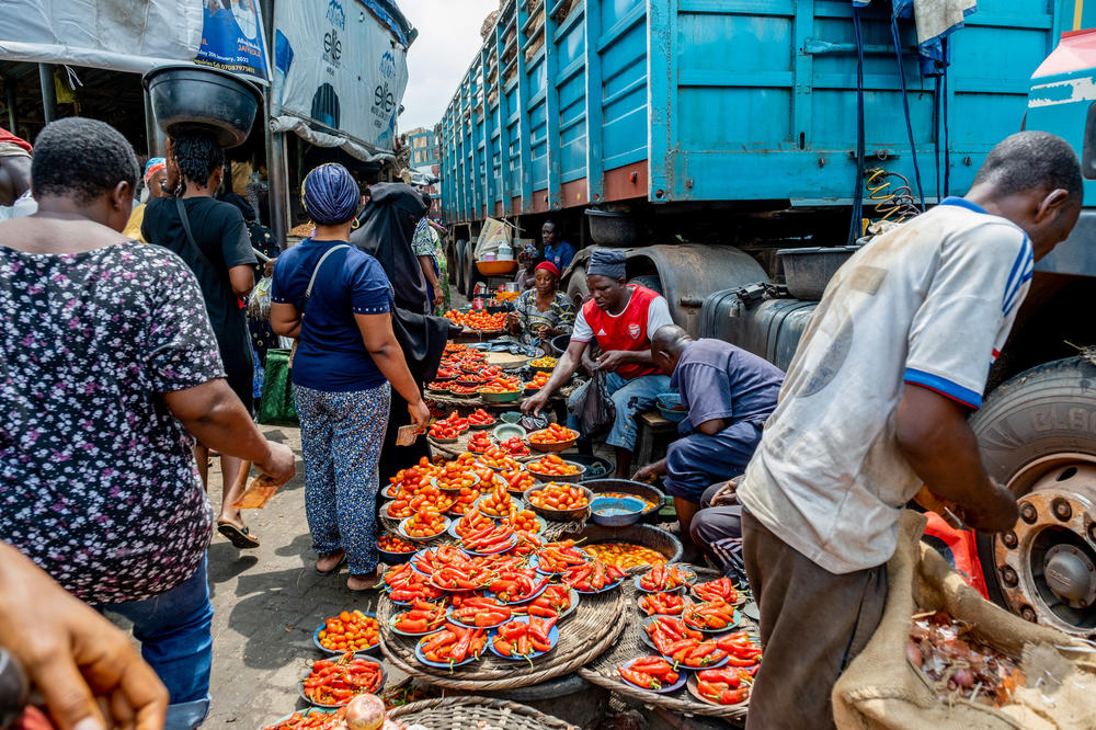 Customers line up to buy fresh peppers at the Mile 12 food market in Lagos, Nigeria, on July 7. Soaring inflation could push 15 million more Nigerians into extreme poverty by the end of this year, the World Bank says.