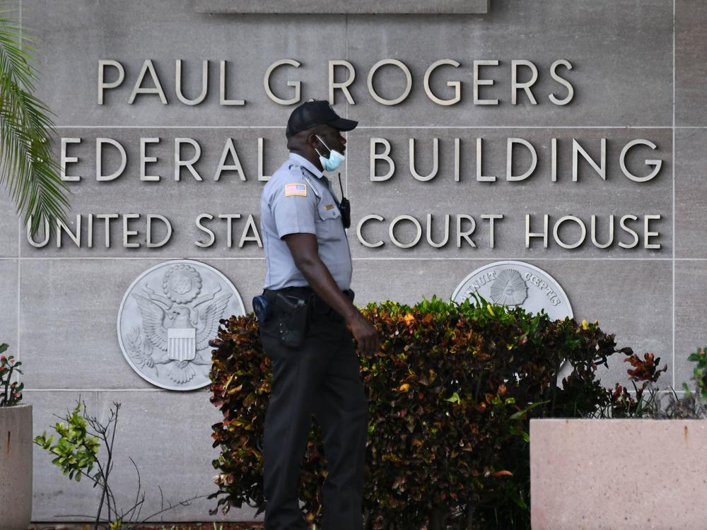 A security officer guards the entrance to the Paul G. Rogers Federal Building and Courthouse in West Palm Beach, Fla., on Thursday, where a federal judge presided over arguments at a hearing on former President Donald Trump's request for a special master to review classified documents the FBI seized from his home last month.