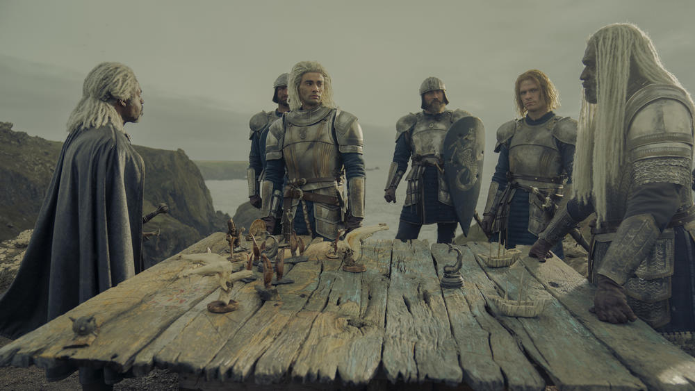Velaryon Roll Call! Vaemond (Wil Johnson), Leanor (Theo Nate) and Corlys (Steve Touissant) play toy soldiers.