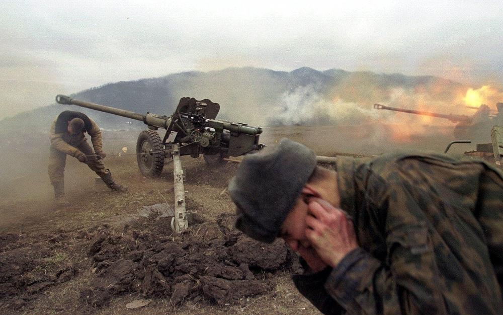 Russian soldiers fire artillery at Chechen positions near the village of Duba-Yurt, 18 miles south of the Grozny, Chechnya, on Jan. 23, 2000.