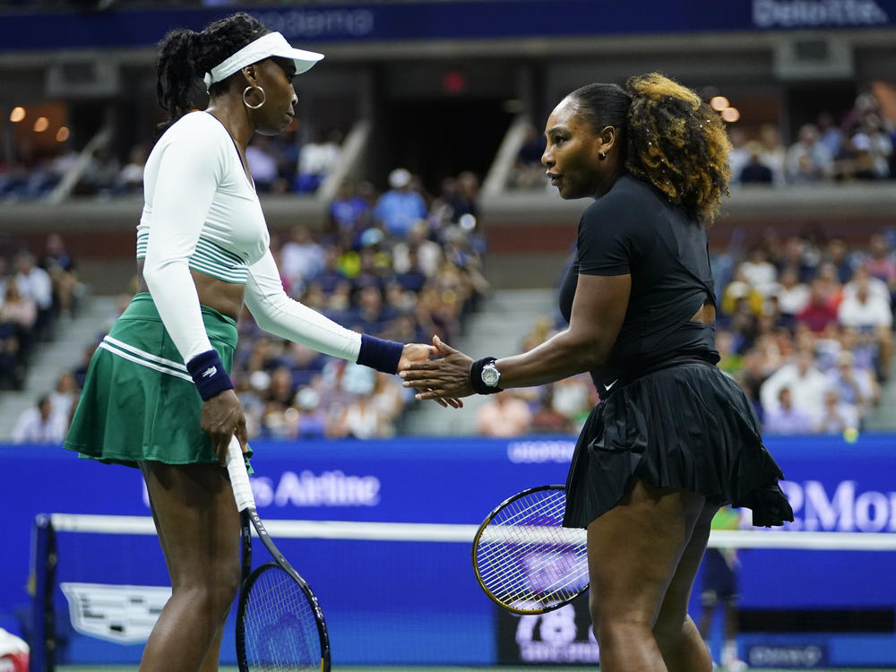 Serena Williams, right, and Venus Williams celebrate during their first-round doubles match against Lucie Hradecká and Linda Nosková, of the Czech Republic, at the U.S. Open tennis championships.