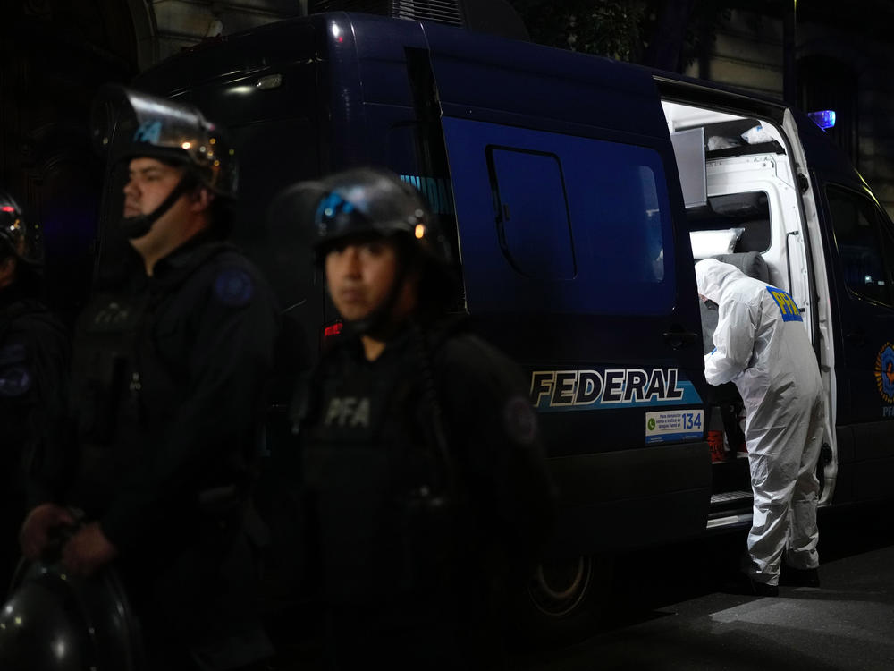 A police investigator works in his van at the scene where a man pointed a gun at Argentina's Vice President Cristina Fernandez during an event in front of her home in Buenos Aires, Argentina, Sept. 1, 2022.