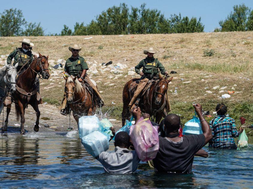 The woman identified in court papers as Esther (far right) was among Haitian migrants who say they were threatened by Border Patrol agents on horseback last September as they tried to return to a makeshift camp in Del Rio, Texas.