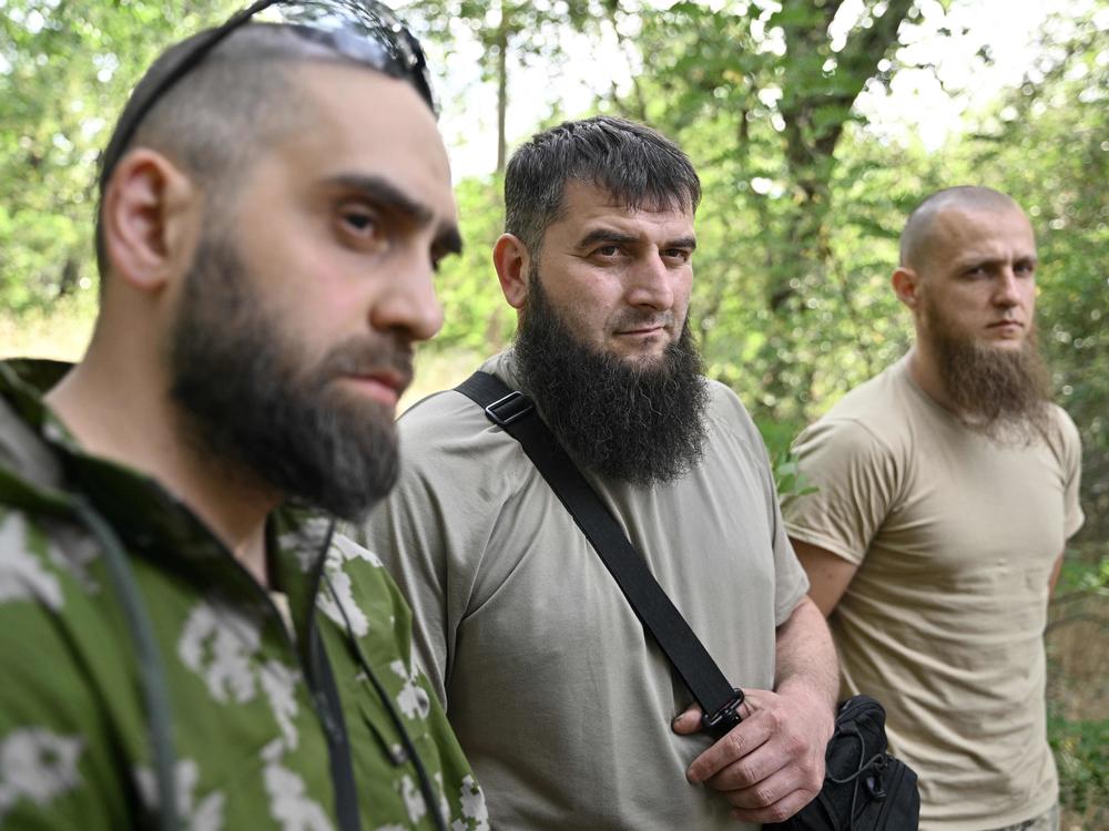 Members of the volunteer Sheikh Mansur Battalion (from left) Islam, Mansur and Asadulla speak to an AFP journalist during an interview in Zaporizhzhia on June 9. The Sheikh Mansur Battalion was founded in 2014 after the annexation of Crimea and composed mainly of Chechen veterans. The group was named after a Chechen military commander against Russian expansion in the Caucasus in the 18th century.