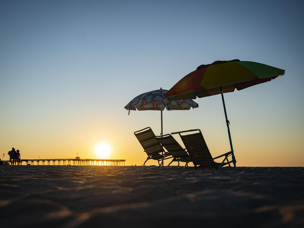 Beach chairs are seen as the sun rises in Ocean City, N.J., on Aug. 18. This is not the above-average hurricane season experts predicted — at least, not yet.