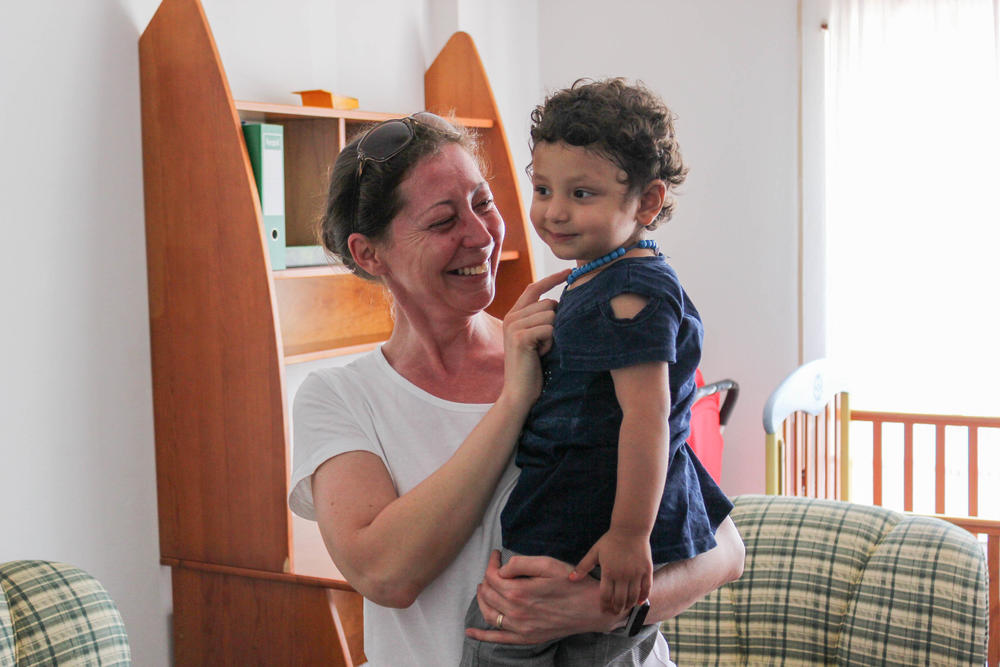 Amina, now 2, with volunteer Ivett Szuro-Luz, who helped the family get a medical visa so they could seek treatment outside Afghanistan. The photo is dated July 30.