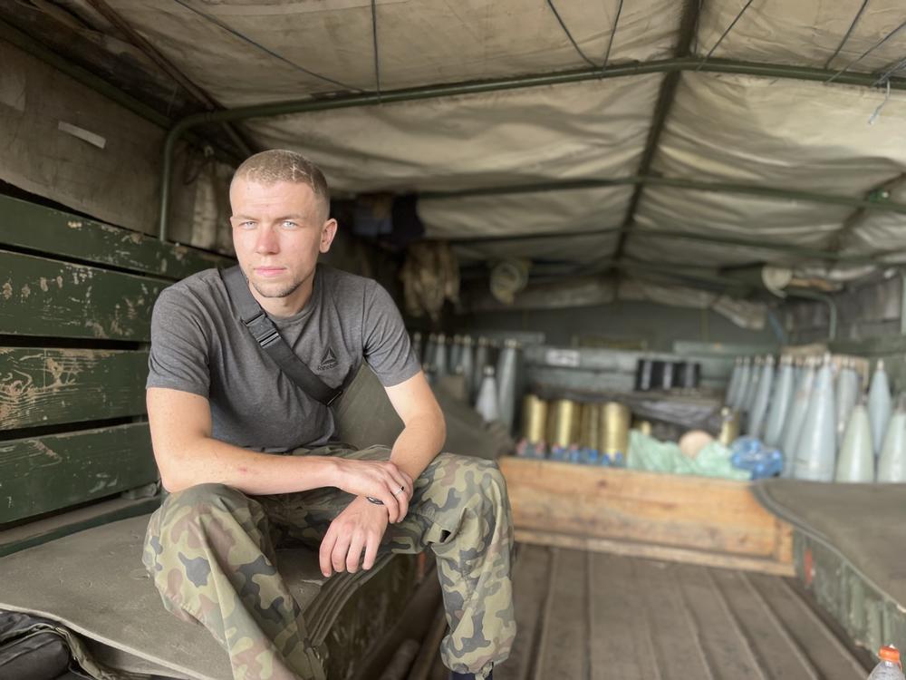 Artem, 24, helps operate a Soviet-era howitzer that the Ukrainian army seized from the Russians, in the Mykolaiv region on Aug. 23. He is seated in a truck filled with howitzer shells but he says the Cold War relic will have to be retired in a few weeks because they are running out of ammunition for it.