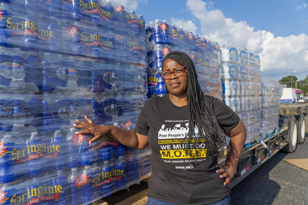 Danyelle Holmes, an activist with Mississippi's Poor People Campaign, stands for a portrait at the Westland Plaza Parking Lot as she helps distribute water in Jackson.