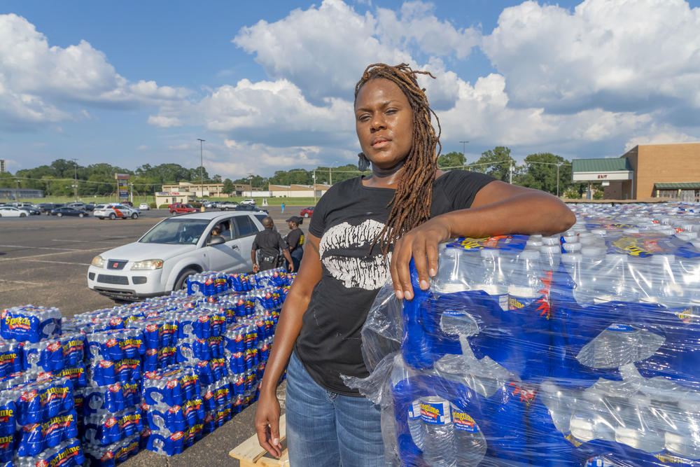 Halima Olufemi, an activist with the People's Advocacy Institute, stands for a portrait at the Westland Plaza Parking Lot as she helps distribute water.