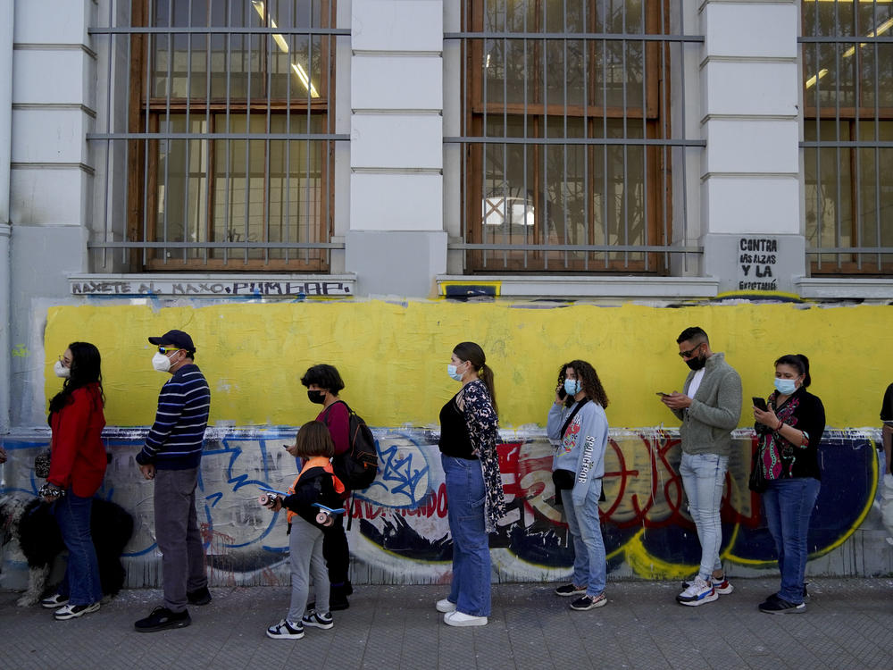 People line up to vote in a plebiscite on a new draft of the Constitution in Santiago, Chile, Sunday.