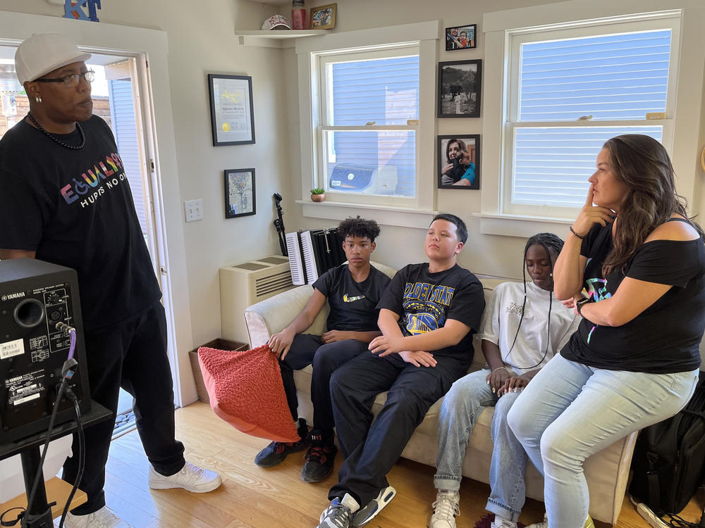 The group chats during a rehearsal at their Oakland studio