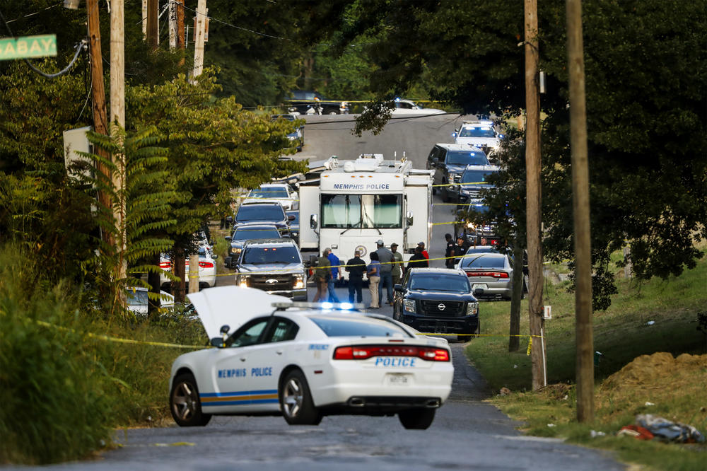 Memphis police officers search an area where a body had been found in South Memphis, Tenn., on Monday.