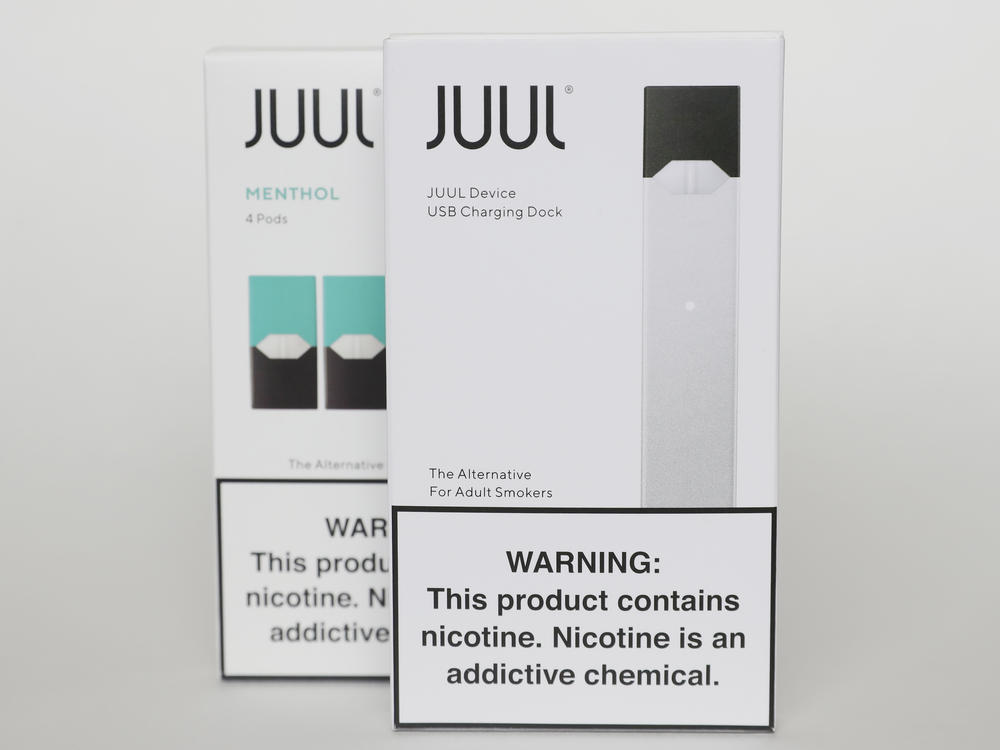 Packaging for an electronic cigarette and menthol pods from Juul Labs is displayed on Feb. 25, 2020, in Pembroke Pines, Fla. In a deal announced Tuesday, Juul will pay nearly $440 million to settle a two-year investigation by 33 states into the marketing of its high-nicotine vaping products.