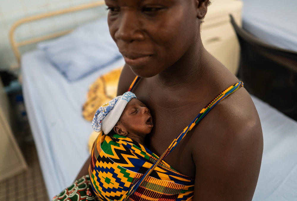 Day Adeline, 40, looks on as she rests in a bed holding one of her twins at the Kangaroo Care ward. They were born at 32 weeks and weighed under 4 pounds, so doctors say it is too risky to take them home. She has not left the ward since her twins were born.
