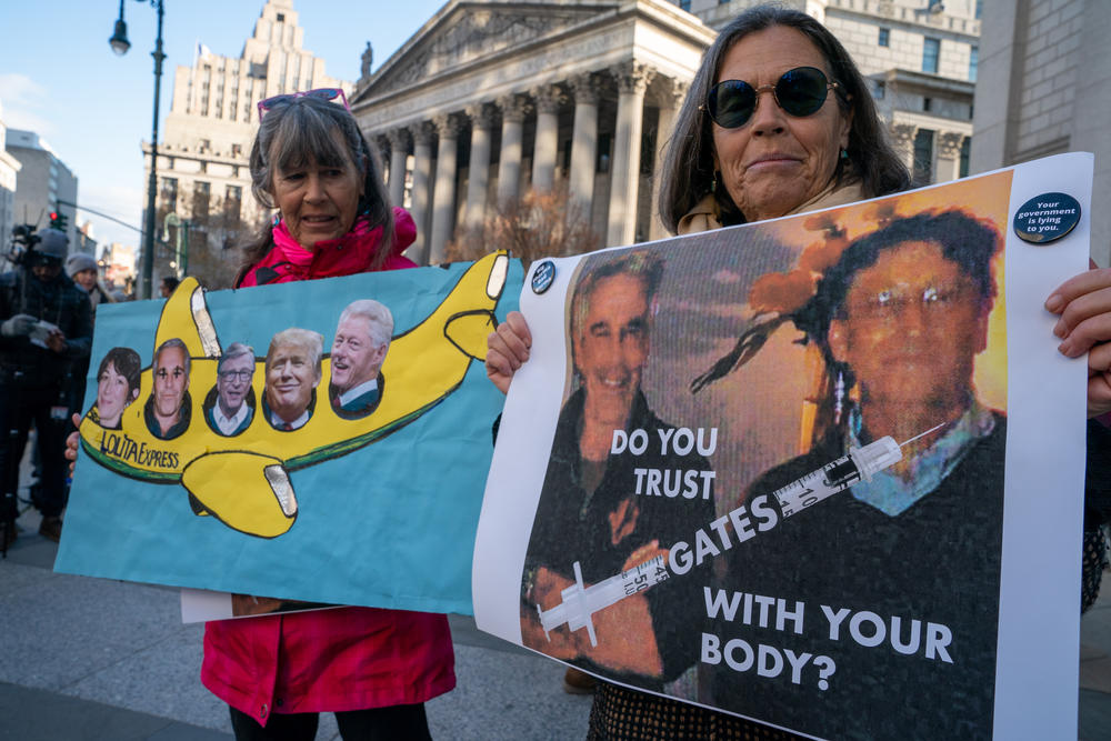 Protesters with signs linking the late Jeffrey Epstein to conspiracy theories at the sex trafficking trial of his accomplice, Ghislaine Maxwell , in November 2021 in New York City.