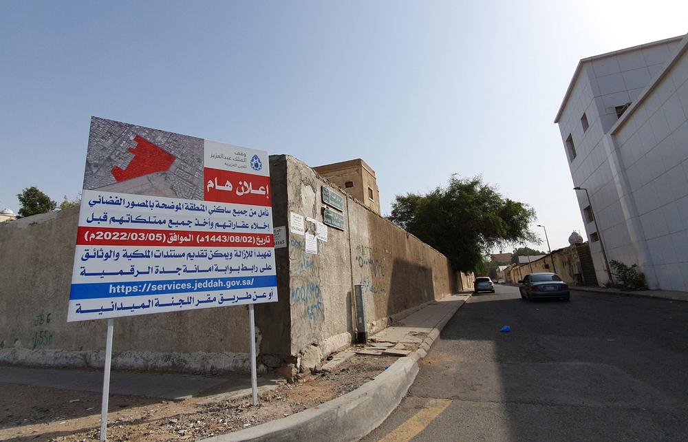 A sign at the entrance of a neighborhood warns residents to leave their homes with their belongings before demolition. The Saudi government is revamping large parts of Jeddah.