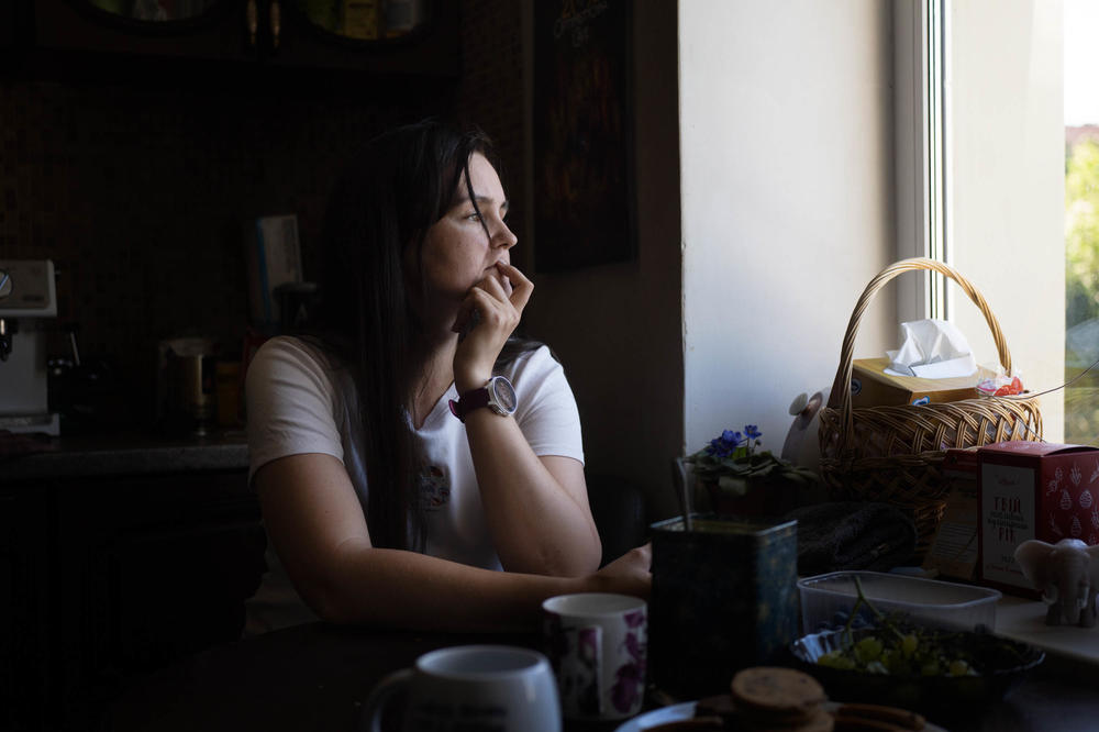 Svitlana Sheremet looks out her kitchen window in Dnipro.