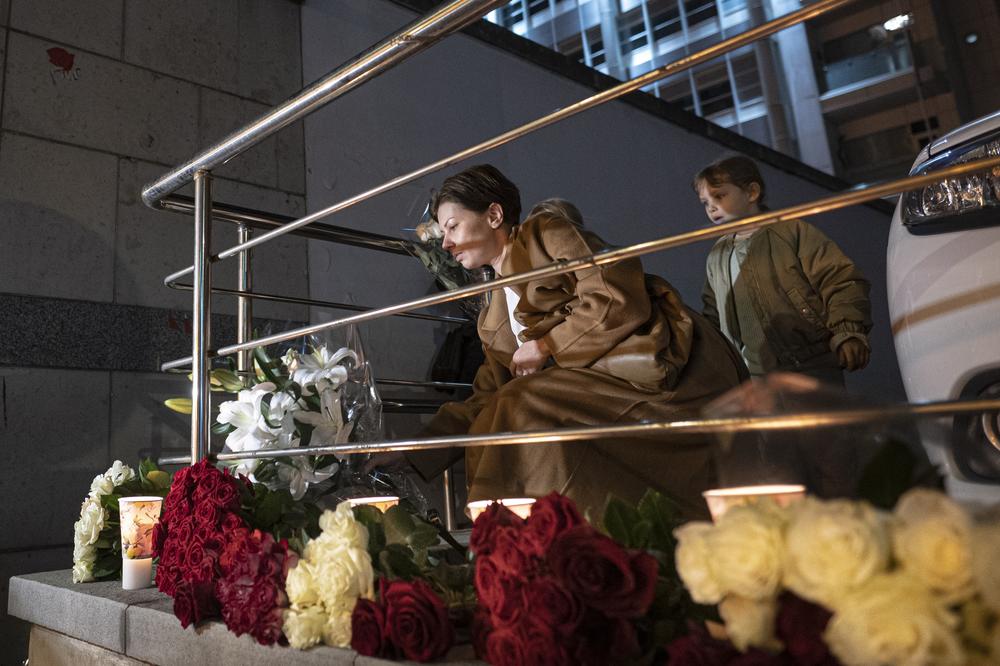 People lay flowers in remembrance of Queen Elizabeth II at the U.K. Embassy in Moscow on Thursday.