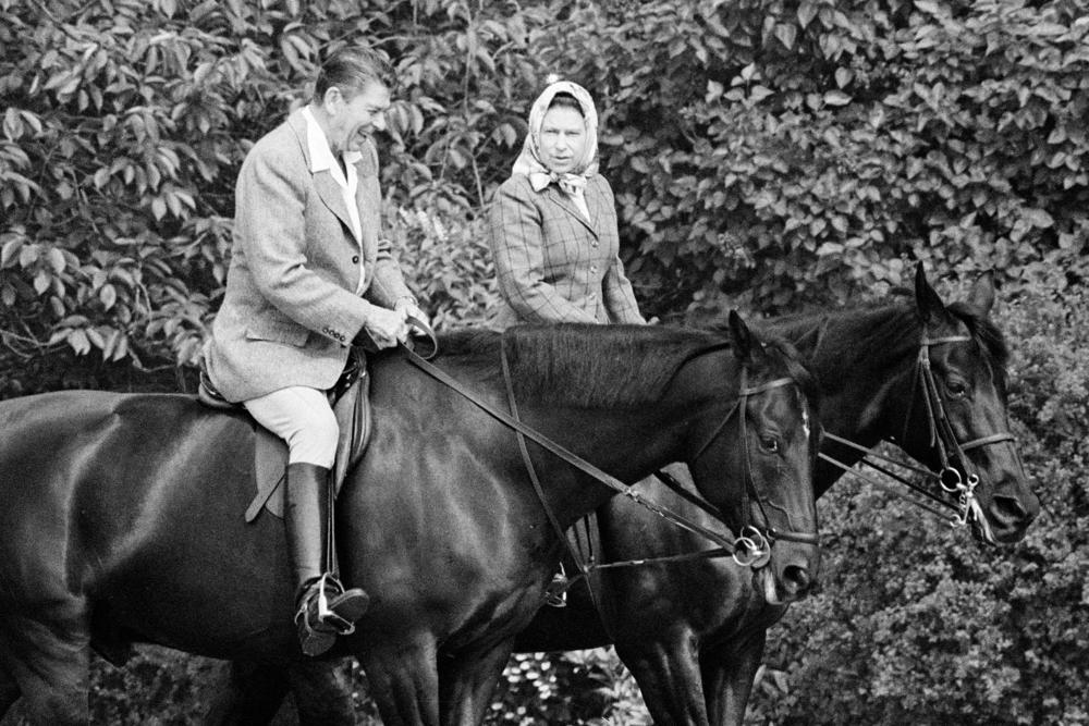 President Ronald Reagan and Queen Elizabeth II go horseback riding in the grounds of Windsor Castle, England on June 8, 1982.