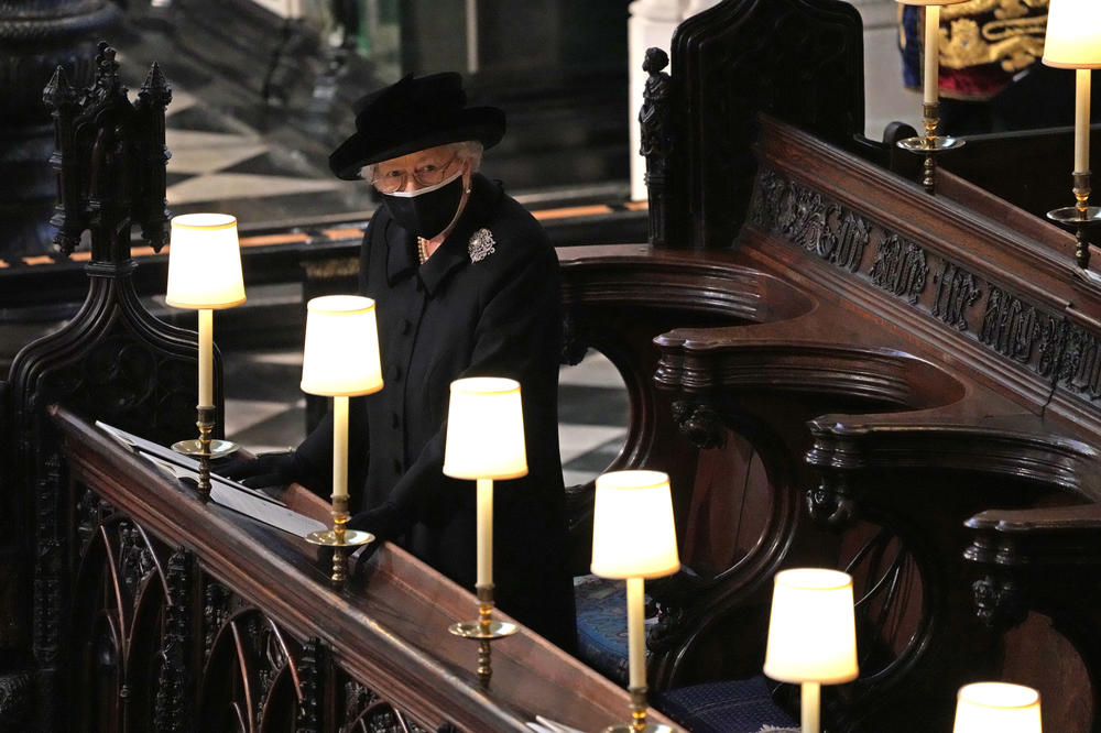 Queen Elizabeth II watches as pallbearers carry the coffin of Prince Philip, Duke Of Edinburgh into St George's Chapel on April 17, 2021, in Windsor, United Kingdom. He served as prince consort to Queen Elizabeth II until his death on April 9, 2021, months short of his 100th birthday. His funeral took place at Windsor Castle with only 30 guests invited due to coronavirus pandemic restrictions.