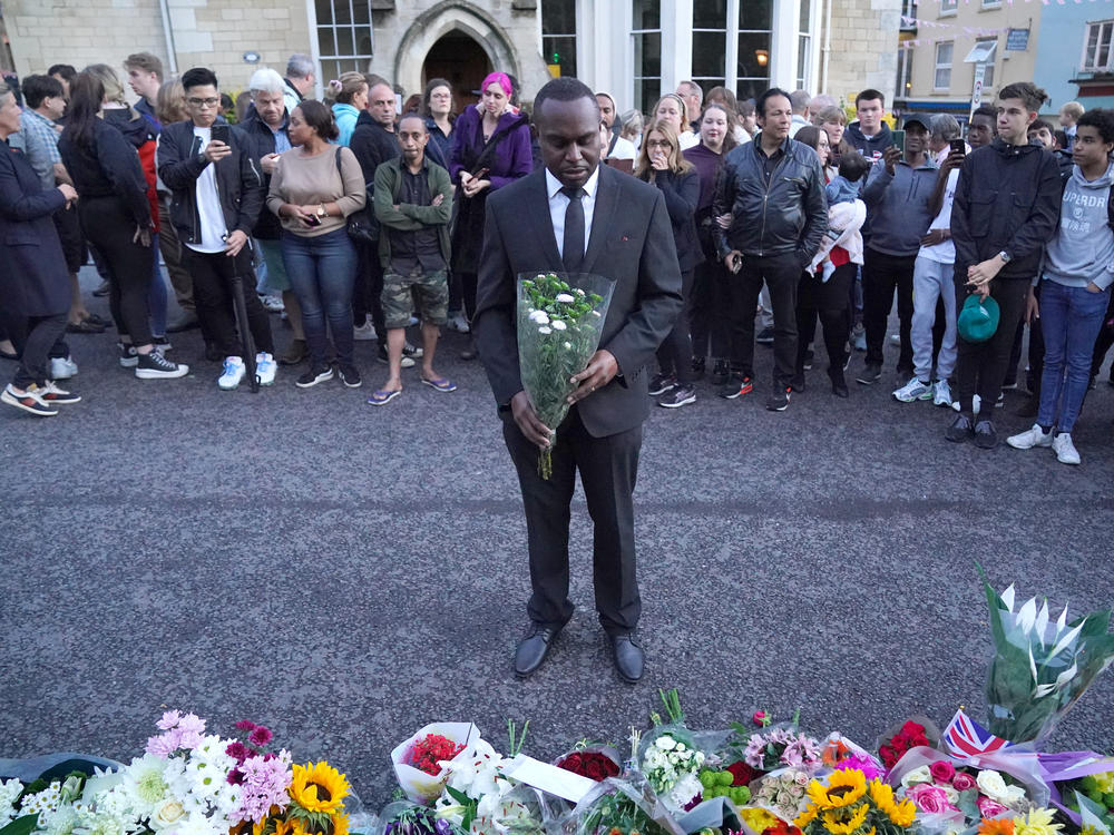 Mourners gather to lay flowers outside Windsor Castle in Berkshire following the announcement of the death of Queen Elizabeth II on Thursday.