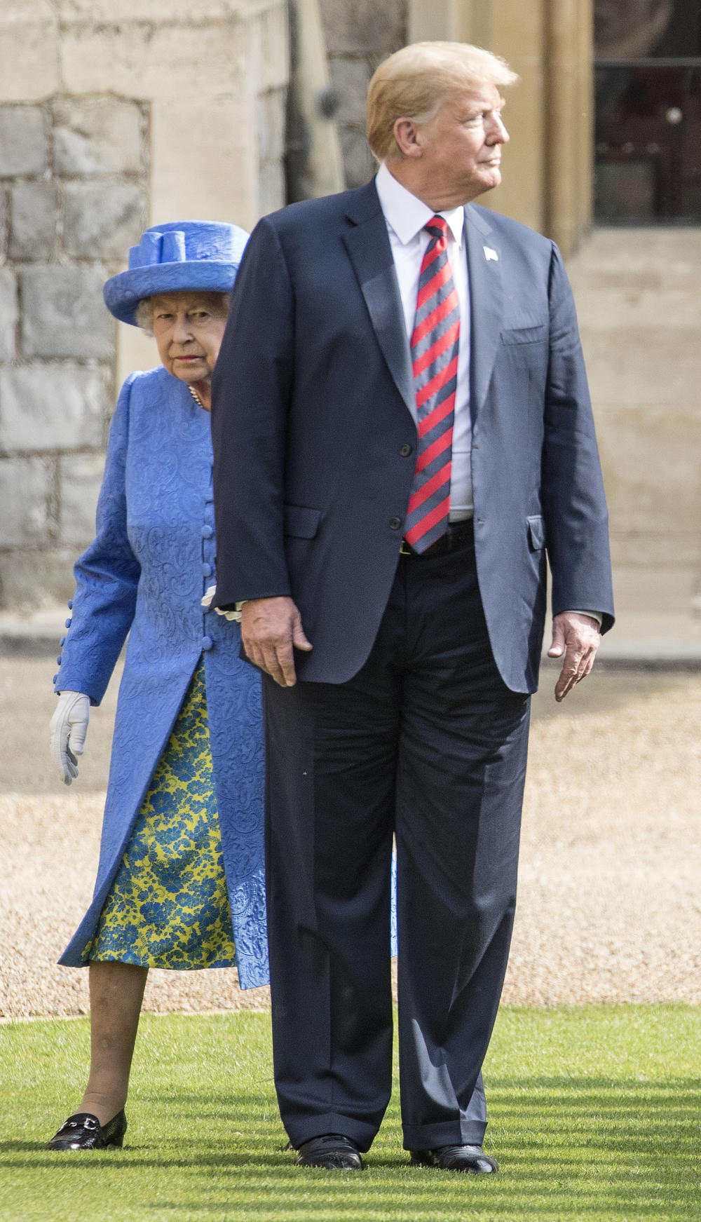 President Donald Trump steps in front of Queen Elizabeth II at Windsor Castle in Windsor, England on July 13, 2018.