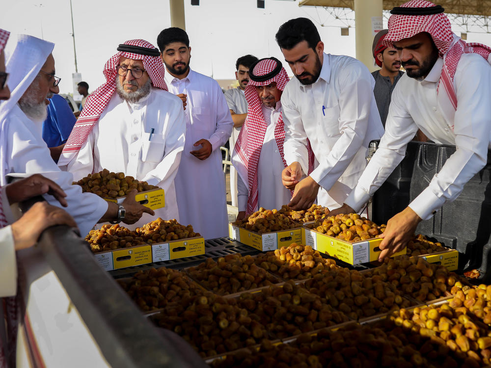 Boxes of dates are auctioned off by the tens of kilos at the Buraydah Date Festival in Buraydah, Saudi Arabia, on Aug. 3, 2022.