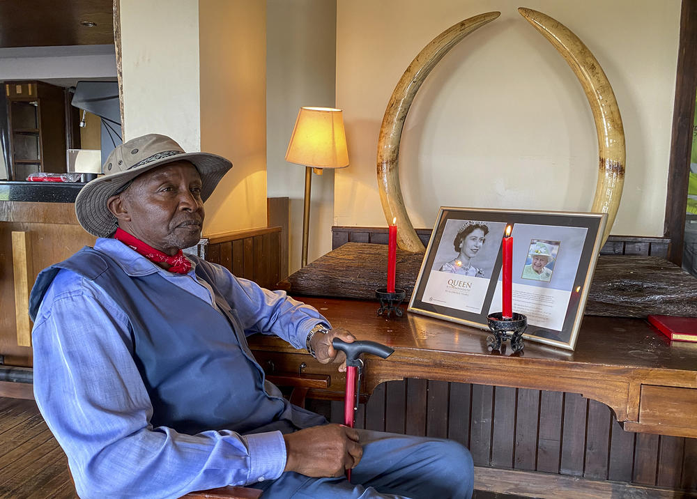 Amos Ndegwa, a naturalist and tour guide, lights a candle to pay tribute to Queen Elizabeth II in the lounge of Treetops Hotel in Aberdare National Park in Kenya on Friday. Elizabeth spent her last night as a princess in Treetops, as she was there in 1952 when her father, King George VI, died in England. Treetops is now closed due to a drop in tourist numbers during the COVID-19 pandemic.