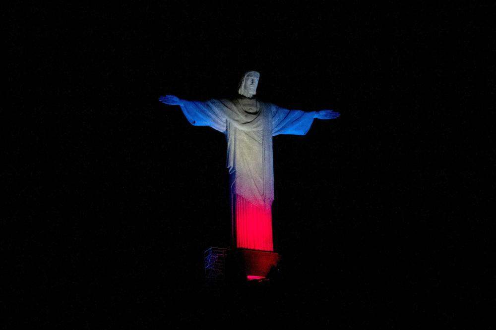 The statue of Christ the Redeemer bears the colors of the British flag on Thursday in Rio de Janeiro. Brazil's President Jair Bolsonaro declared three days of national mourning in the country 
