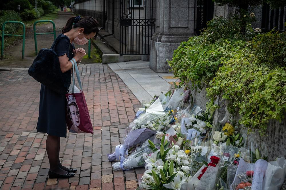 A woman prays outside the British Embassy in Tokyo on Friday.