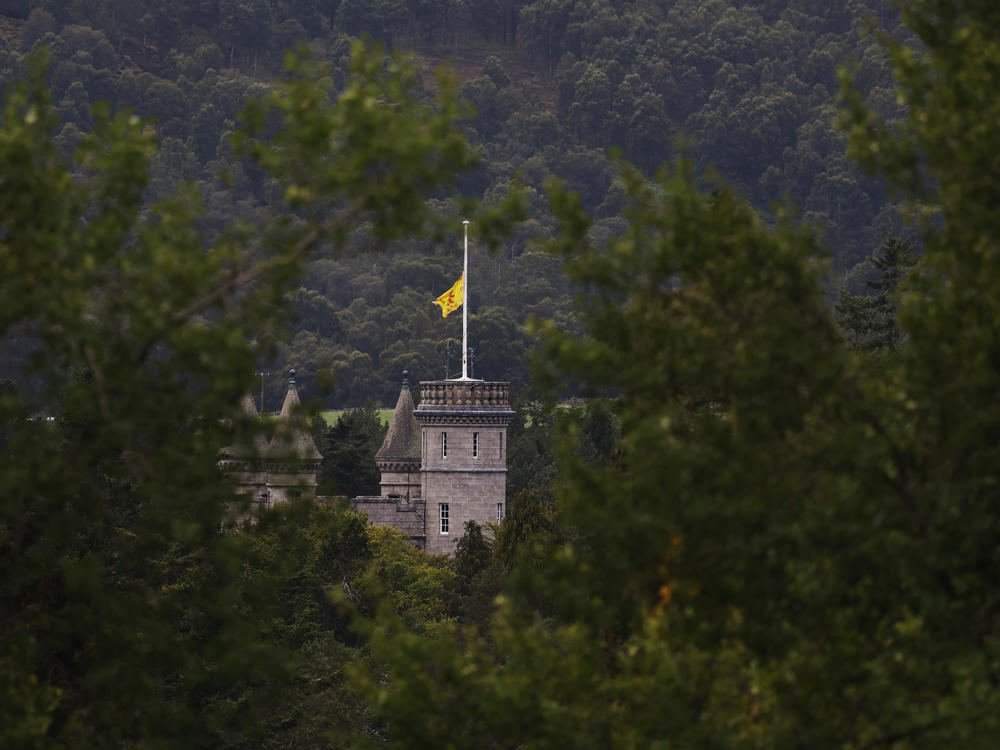 A Lion Rampant flag flies at half-staff at Balmoral Castle in Scotland on Friday. Queen Elizabeth II died at Balmoral on Thursday and is succeeded by her eldest son, King Charles III.