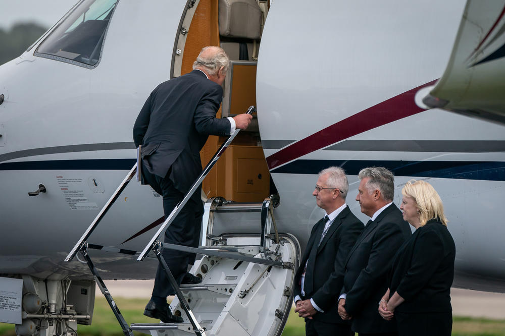 King Charles III boards a plane at Aberdeen Airport as he travels to London with Camilla, Queen Consort, on Friday, following the death of Queen Elizabeth II.