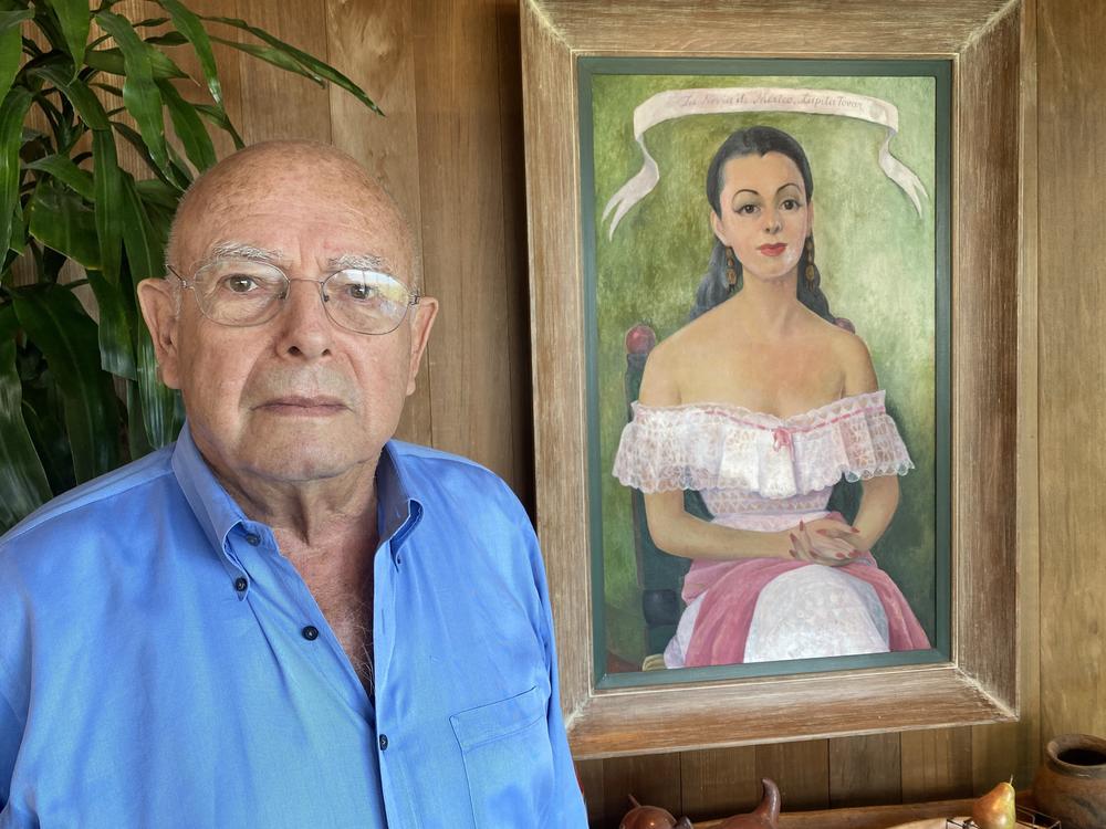 Pancho Kohner, in front of a portrait of his mother, Lupita Tovar, painted by Mexican arist Diego Rivera