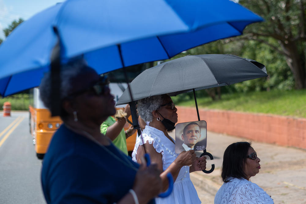 Women listen as U.S. Sen. Raphael Warnock speaks in Americus, Ga., on Aug. 29, 2022.