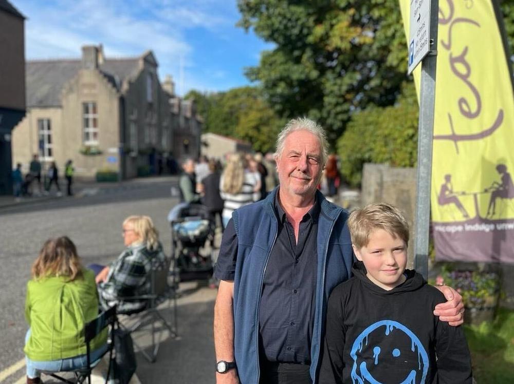 Terry Rigby, 72, a retired air traffic controller, brought his grandson, River, 11, to watch the queen's funeral cortege pass through the Scottish town of Banchory.