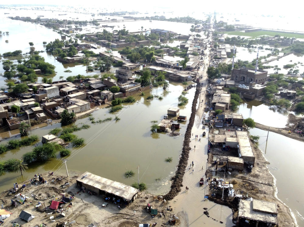 Homes are surrounded by floodwaters in Sohbat Pur city of Jaffarabad, a district of Pakistan's southwestern Baluchistan province, Aug. 29, 2022. The U.N. weather agency predicts the phenomenon known as La Nina is poised to last through the end of this year — its third year in a row — and affect meteorological patterns like drought and flooding worldwide.