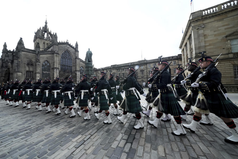 Members of the armed services march near St. Giles' Cathedral in Edinburgh, Scotland.
