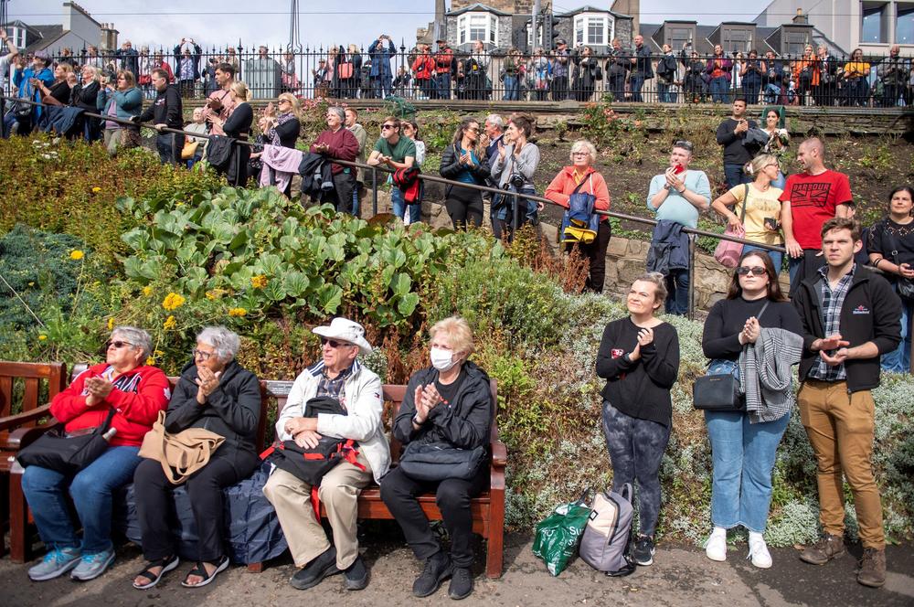 Members of the public gather in Princes Street Gardens to observe the Death Gun Salute fired by 105th Regiment Royal Artillery at Edinburgh Castle.