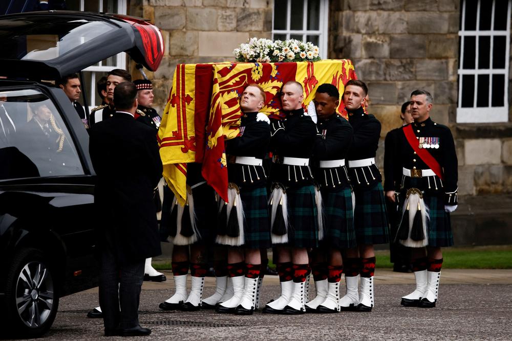Pallbearers carry the coffin of late Britain's Queen Elizabeth II covered with the Royal Standard of Scotland, at the Palace of Holyroodhouse, in Edinburgh.