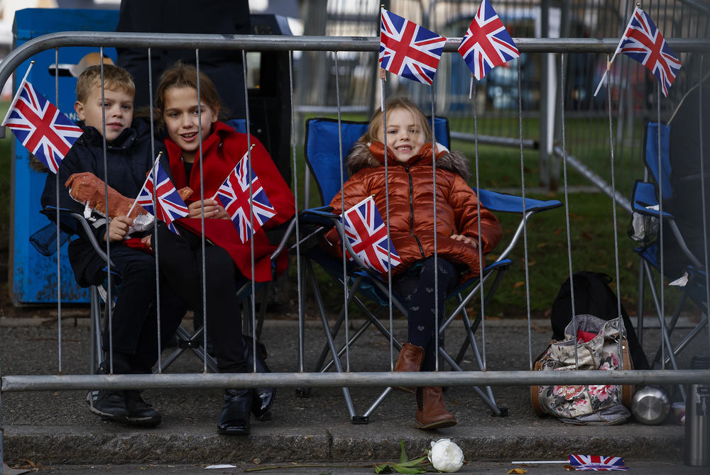 Children gather along the streets as they wait to view the cortege carrying the coffin of the late Queen Elizabeth II in Ballater, Scotland.