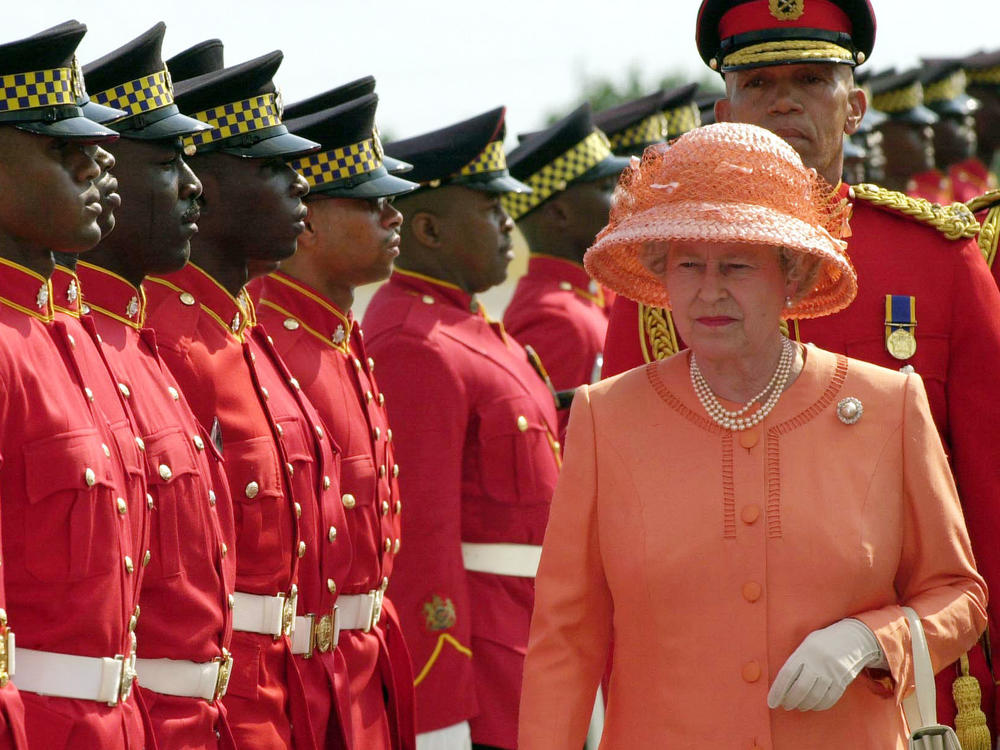 Troops parade for Queen Elizabeth II as she arrives in Kingston, Jamaica, in 2002.