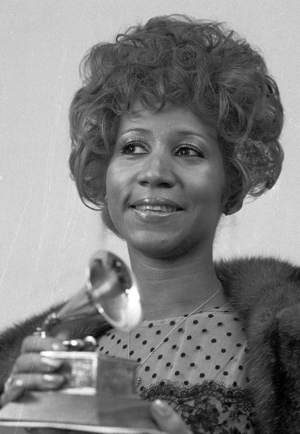In this March 13, 1972 file photo, Aretha Franklin holds her Grammy Award for Best Rhythm and Blue performance of the song 